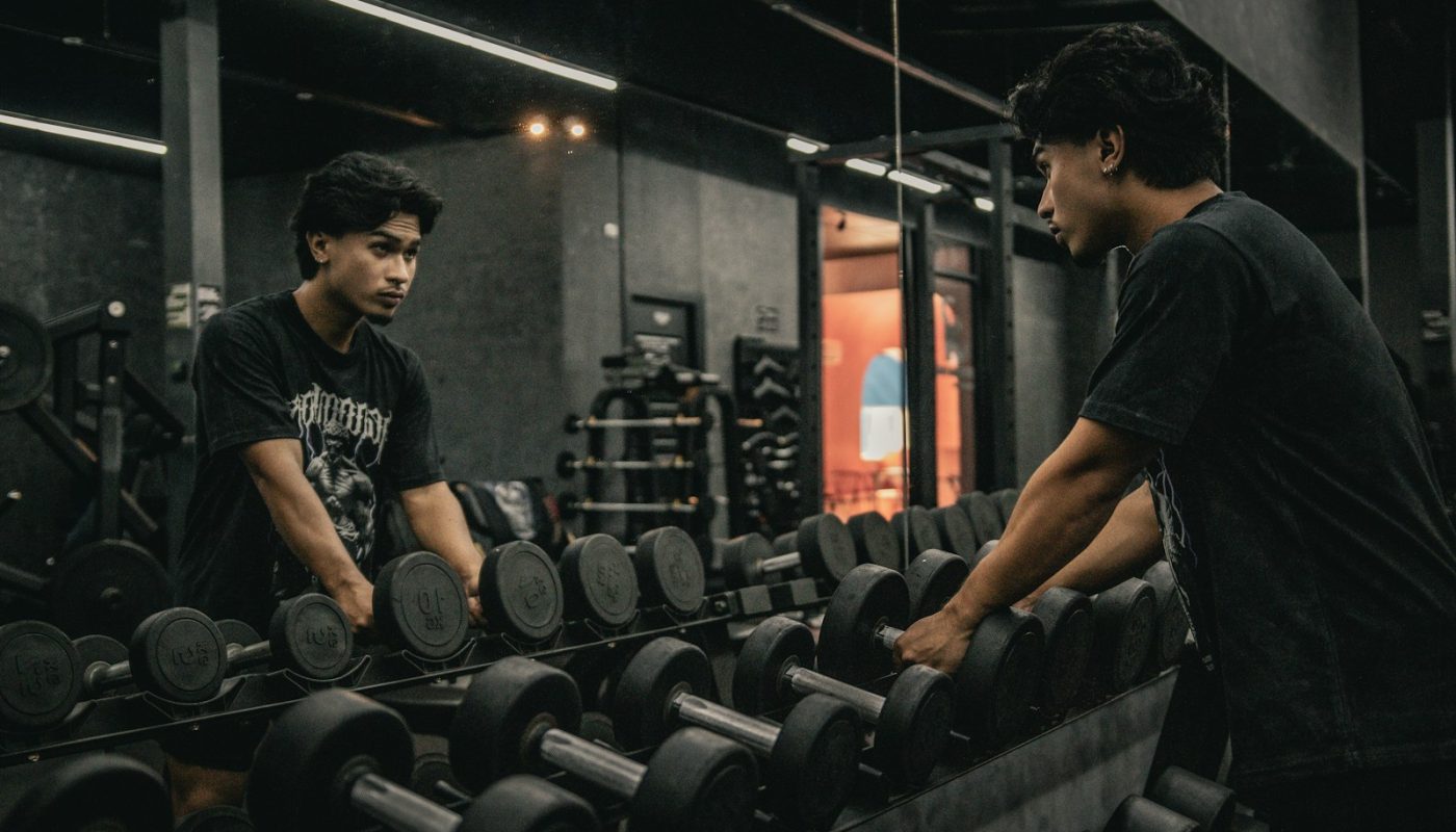 A couple of men working out in a gym