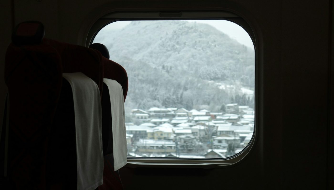 a window with a view of a snowy mountain