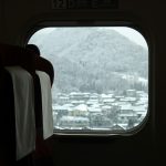 a window with a view of a snowy mountain