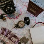 black pocket watch beside banknotes