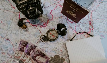 black pocket watch beside banknotes