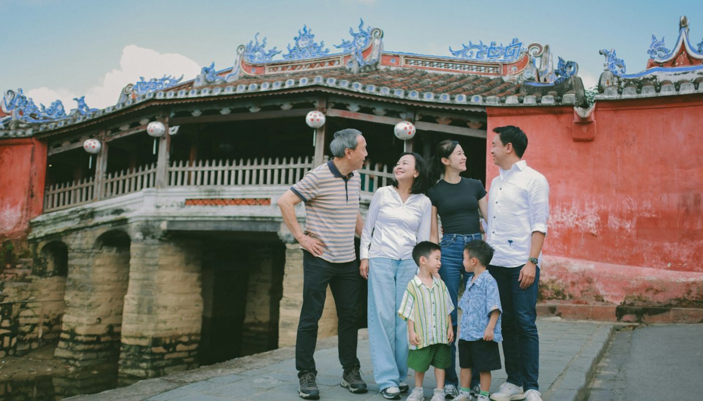 Family posing in front of a historic building